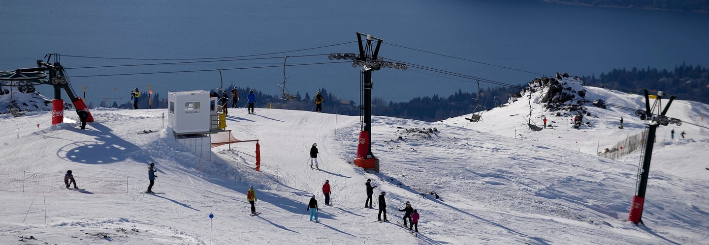 Cerro Catedral Bariloche a ski lift with people skiing down a mountain